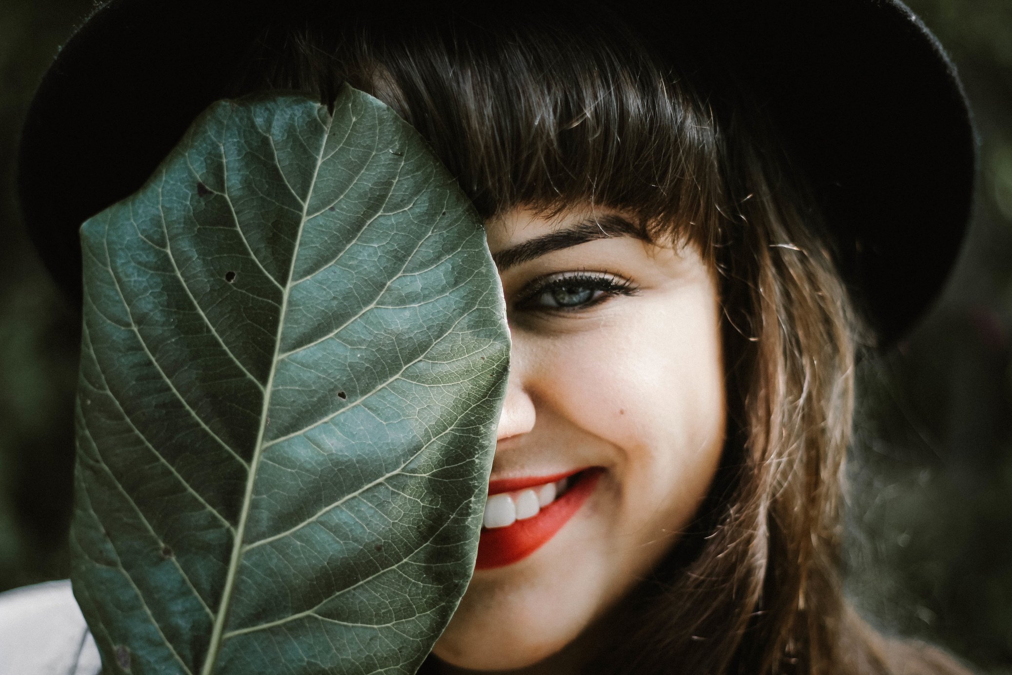 Happy Woman Holding a Leaf